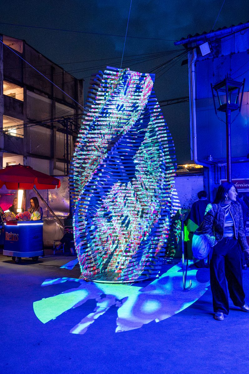 Vista nocturna de la escultura Madera y Futuro en espacio público